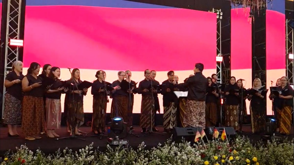 SJCC in traditional dress on an embassy stage